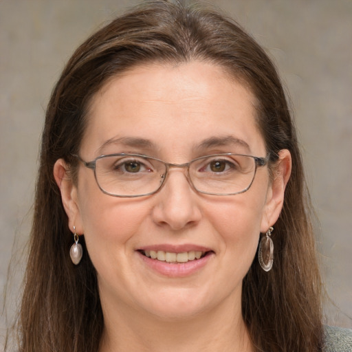 Joyful white adult female with medium  brown hair and grey eyes