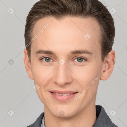 Joyful white young-adult male with short  brown hair and grey eyes