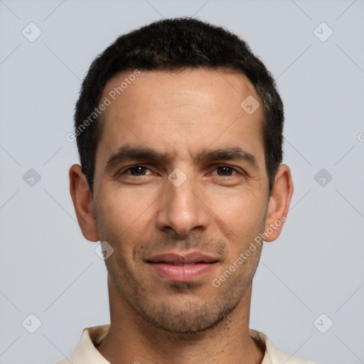 Joyful white young-adult male with short  black hair and brown eyes