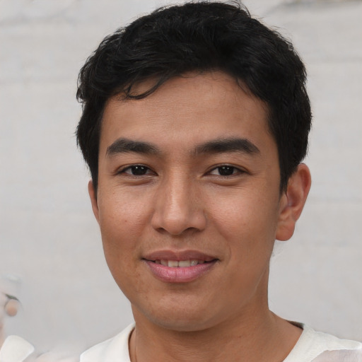 Joyful asian young-adult male with short  brown hair and brown eyes