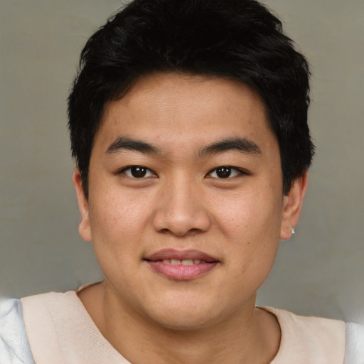 Joyful asian young-adult male with short  black hair and brown eyes