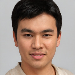 Joyful asian young-adult male with short  black hair and brown eyes