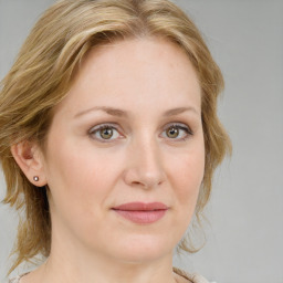 Joyful white young-adult female with medium  brown hair and blue eyes