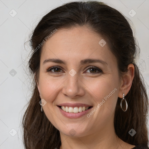 Joyful white young-adult female with long  brown hair and brown eyes