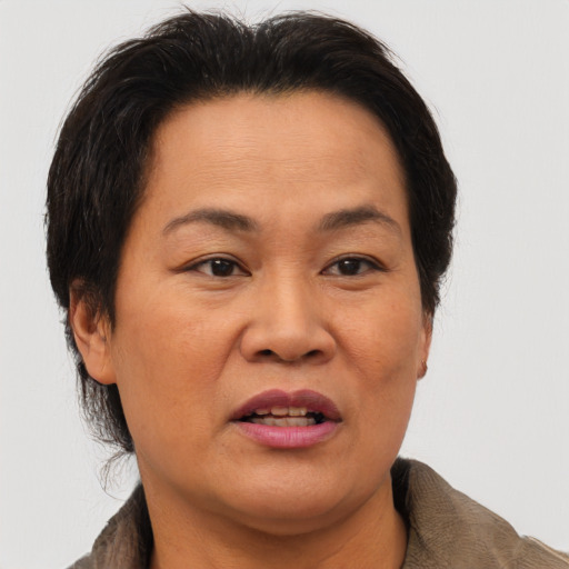 Joyful asian adult female with short  brown hair and brown eyes