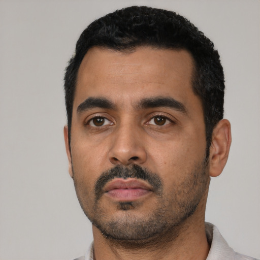 Neutral latino young-adult male with short  black hair and brown eyes