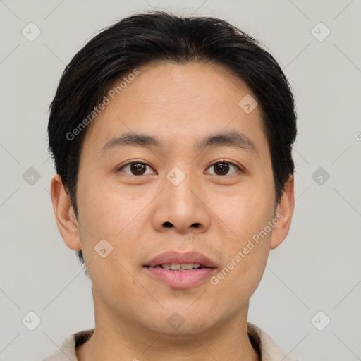 Joyful asian young-adult male with short  brown hair and brown eyes