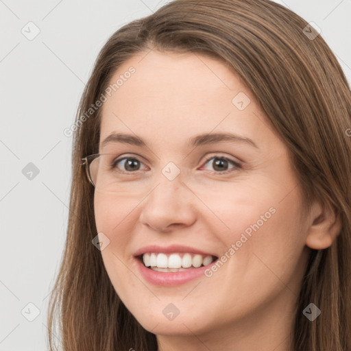 Joyful white young-adult female with long  brown hair and grey eyes