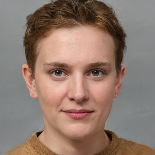 Joyful white young-adult female with short  brown hair and grey eyes