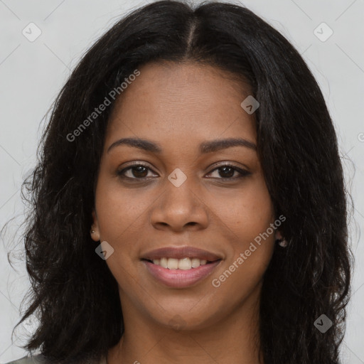 Joyful black young-adult female with long  brown hair and brown eyes