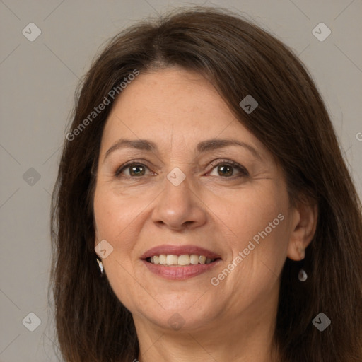 Joyful white adult female with long  brown hair and brown eyes