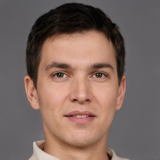 Joyful white young-adult male with short  brown hair and brown eyes