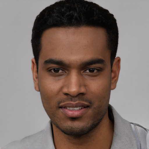 Joyful black young-adult male with short  black hair and brown eyes