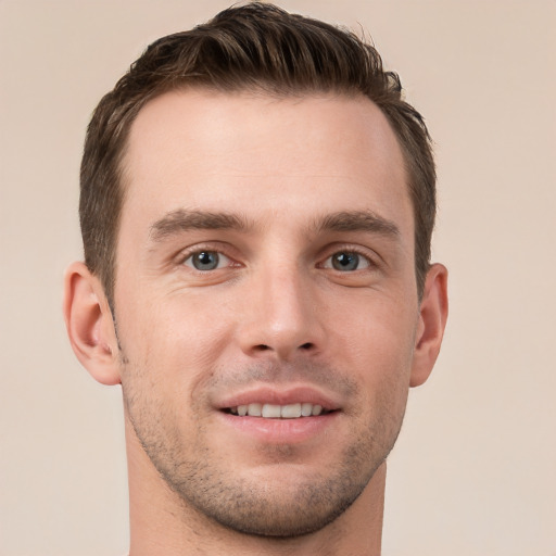 Joyful white young-adult male with short  brown hair and grey eyes