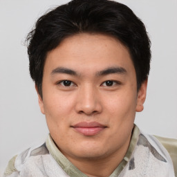 Joyful asian young-adult male with short  brown hair and brown eyes