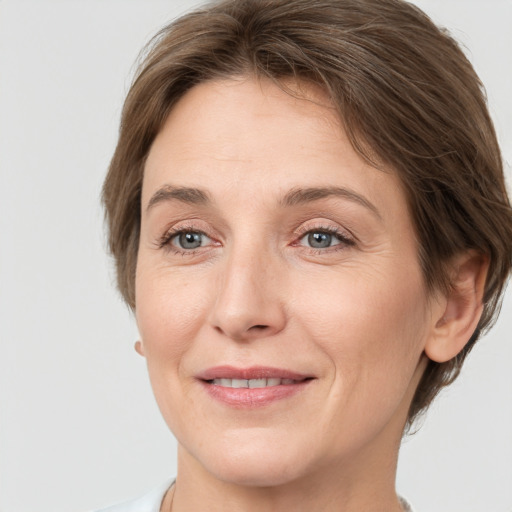 Joyful white adult female with medium  brown hair and grey eyes