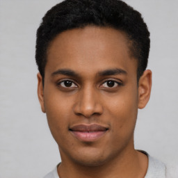Joyful latino young-adult male with short  brown hair and brown eyes
