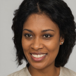 Joyful black young-adult female with medium  brown hair and brown eyes