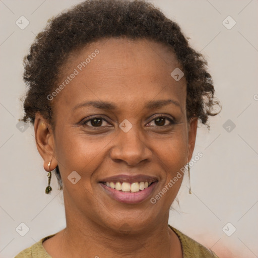 Joyful black adult female with short  brown hair and brown eyes