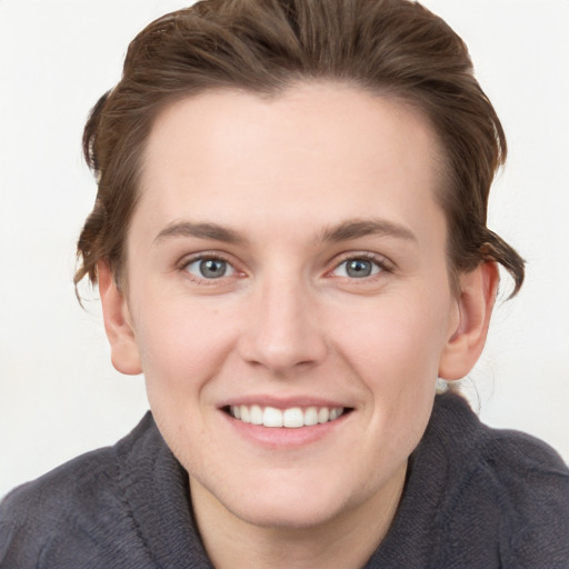 Joyful white young-adult female with short  brown hair and grey eyes