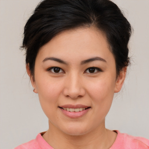 Joyful asian young-adult female with medium  brown hair and brown eyes