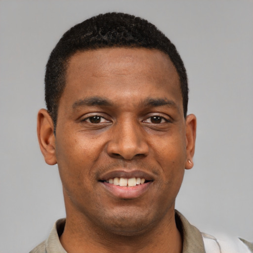Joyful latino young-adult male with short  brown hair and brown eyes