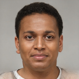 Joyful latino young-adult male with short  brown hair and brown eyes