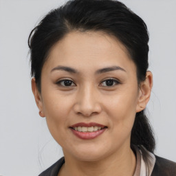 Joyful asian young-adult female with short  brown hair and brown eyes