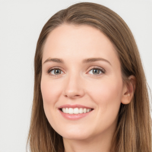 Joyful white young-adult female with long  brown hair and grey eyes