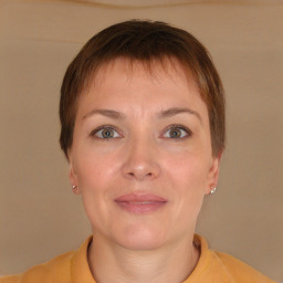 Joyful white adult female with short  brown hair and brown eyes