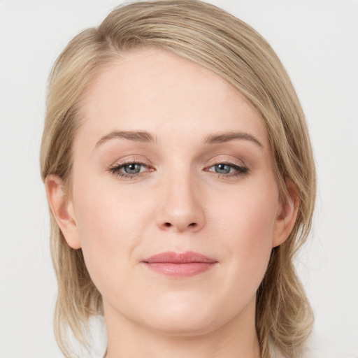 Joyful white young-adult female with medium  brown hair and blue eyes