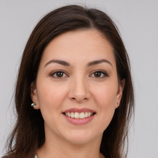 Joyful white young-adult female with long  brown hair and brown eyes