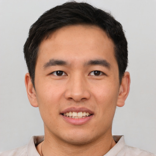 Joyful white young-adult male with short  black hair and brown eyes