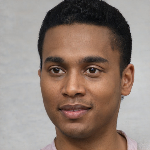 Joyful black young-adult male with short  black hair and brown eyes