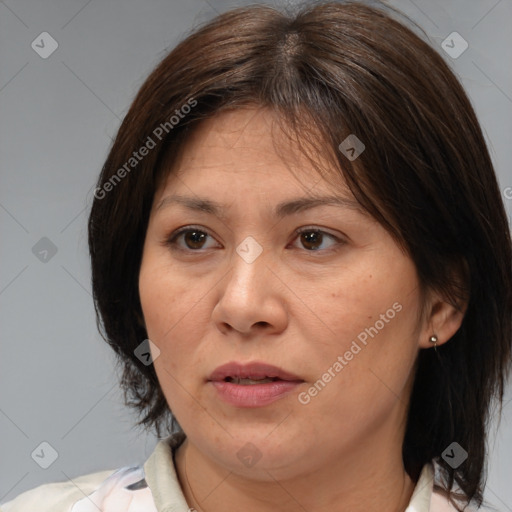 Joyful white adult female with medium  brown hair and brown eyes