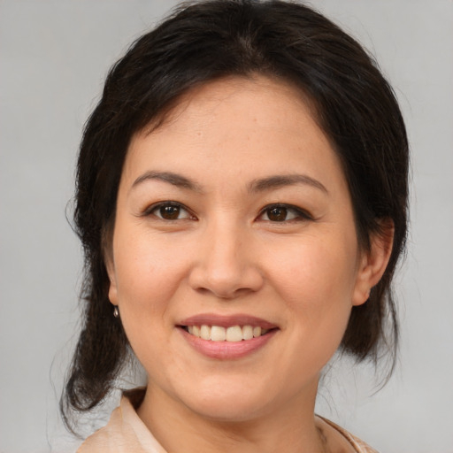 Joyful white young-adult female with medium  brown hair and brown eyes