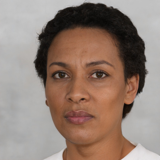 Neutral latino adult female with short  black hair and brown eyes