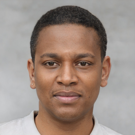 Joyful latino young-adult male with short  brown hair and brown eyes