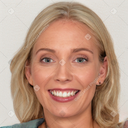 Joyful white adult female with long  brown hair and blue eyes