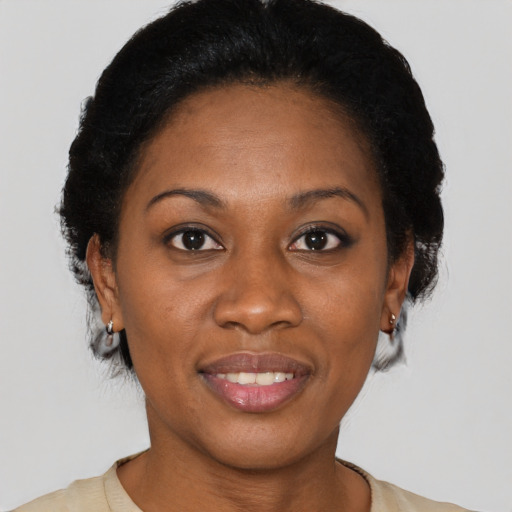 Joyful latino adult female with short  black hair and brown eyes