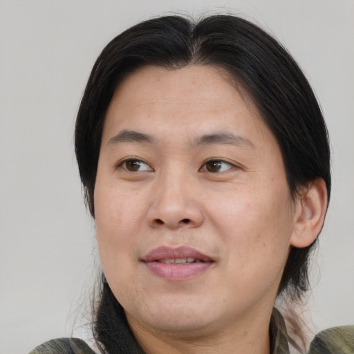 Joyful asian adult male with medium  brown hair and brown eyes