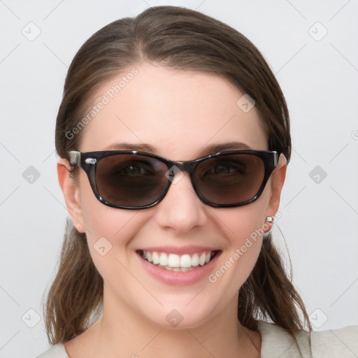 Joyful white young-adult female with medium  brown hair and blue eyes