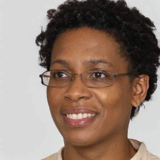 Joyful black adult female with short  brown hair and brown eyes