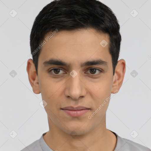 Joyful white young-adult male with short  black hair and brown eyes