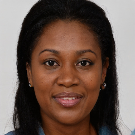 Joyful black young-adult female with long  brown hair and brown eyes