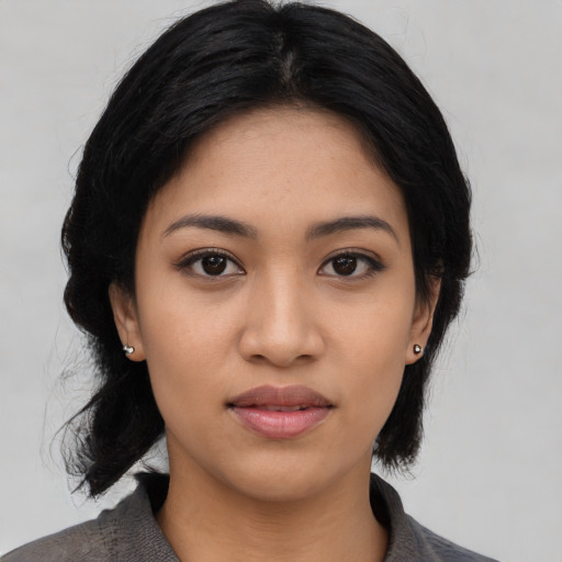 Joyful asian young-adult female with medium  black hair and brown eyes
