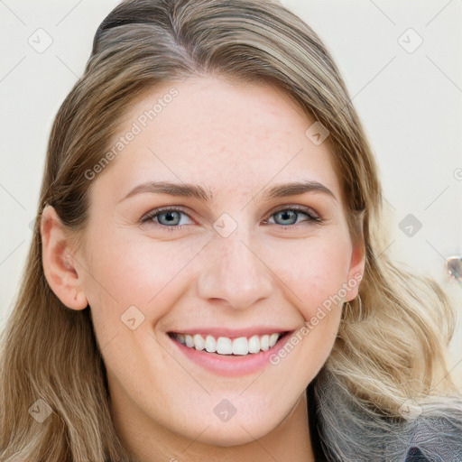 Joyful white young-adult female with long  brown hair and blue eyes