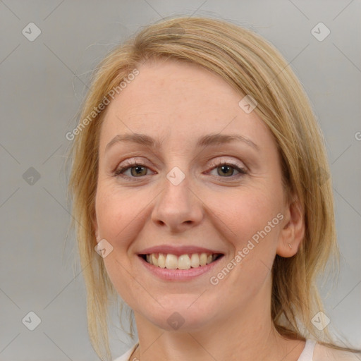 Joyful white adult female with medium  brown hair and blue eyes