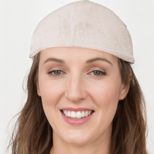 Joyful white young-adult female with long  brown hair and grey eyes