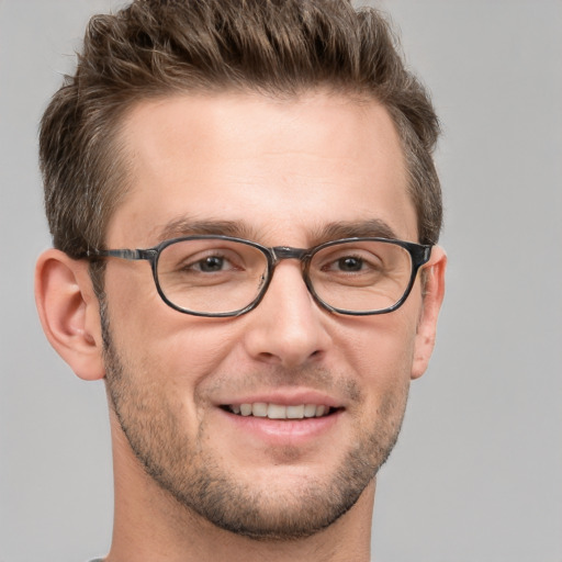 Joyful white adult male with short  brown hair and grey eyes